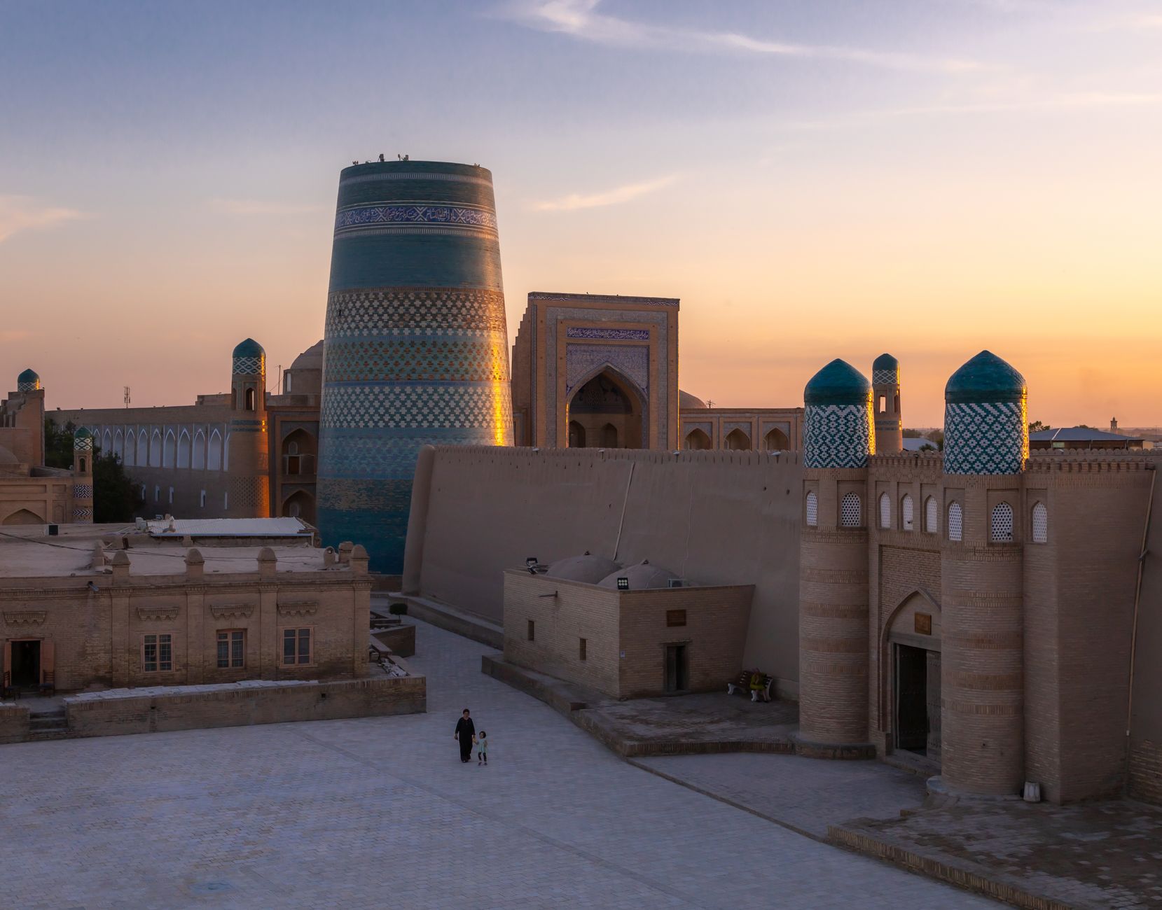 Khiva's historic Itchan Kala during sunset with the iconic Kalta Minor Minaret, Uzbekistan