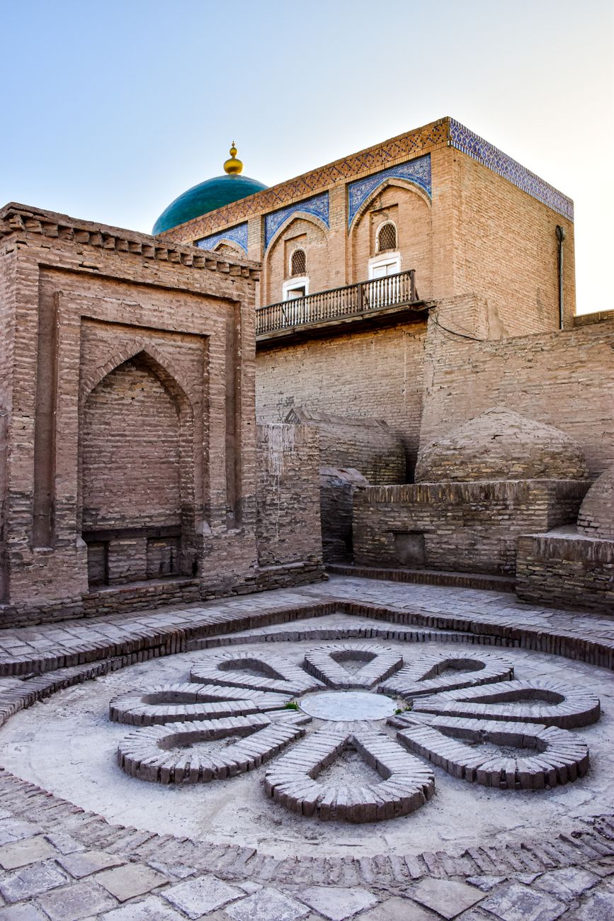 Ancient architecture of Khiva's old town courtyard with intricate brickwork and ornate designs, Uzbekistan