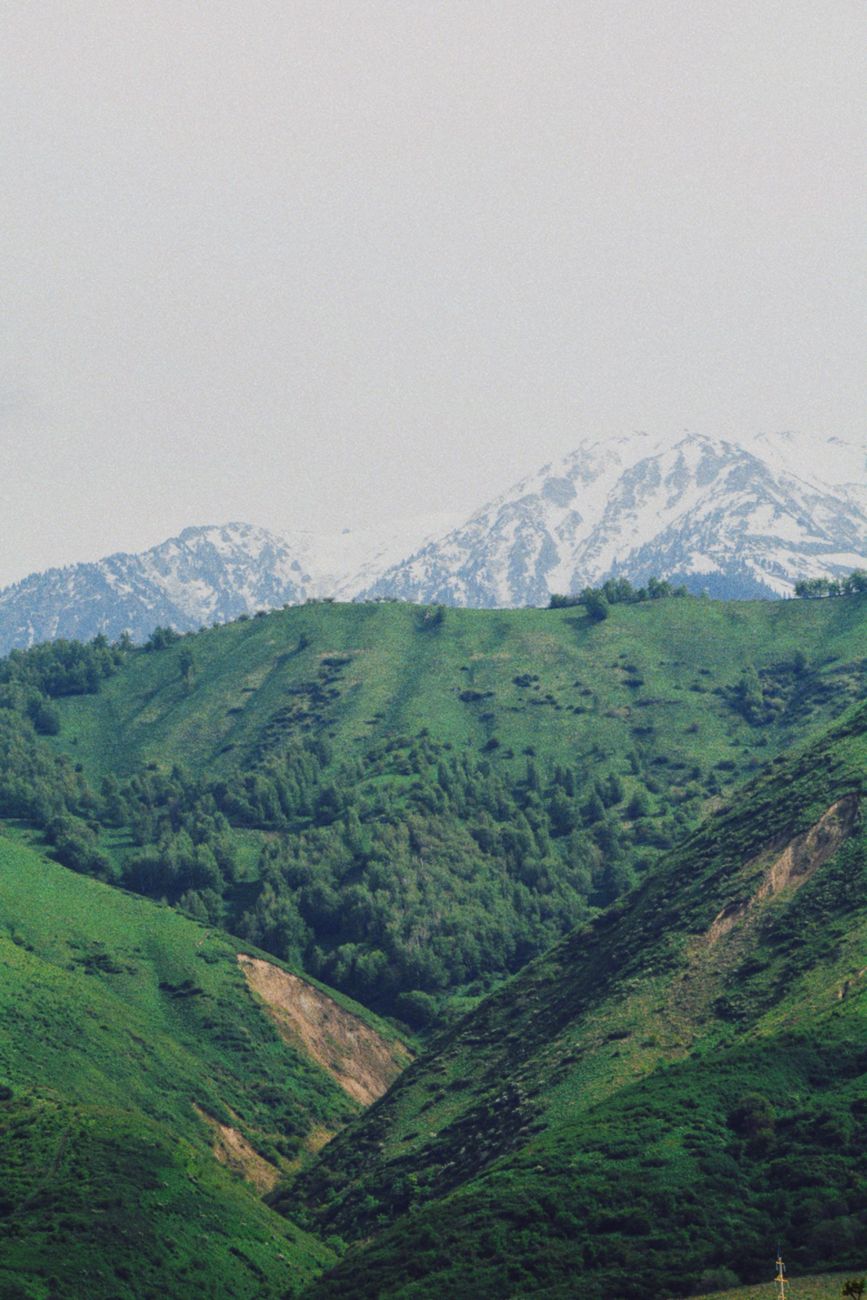 Lush green hills with snow-capped mountains in Talgar, Kazakhstan · Fann Mountains, Tajikistan, Uzbekistan