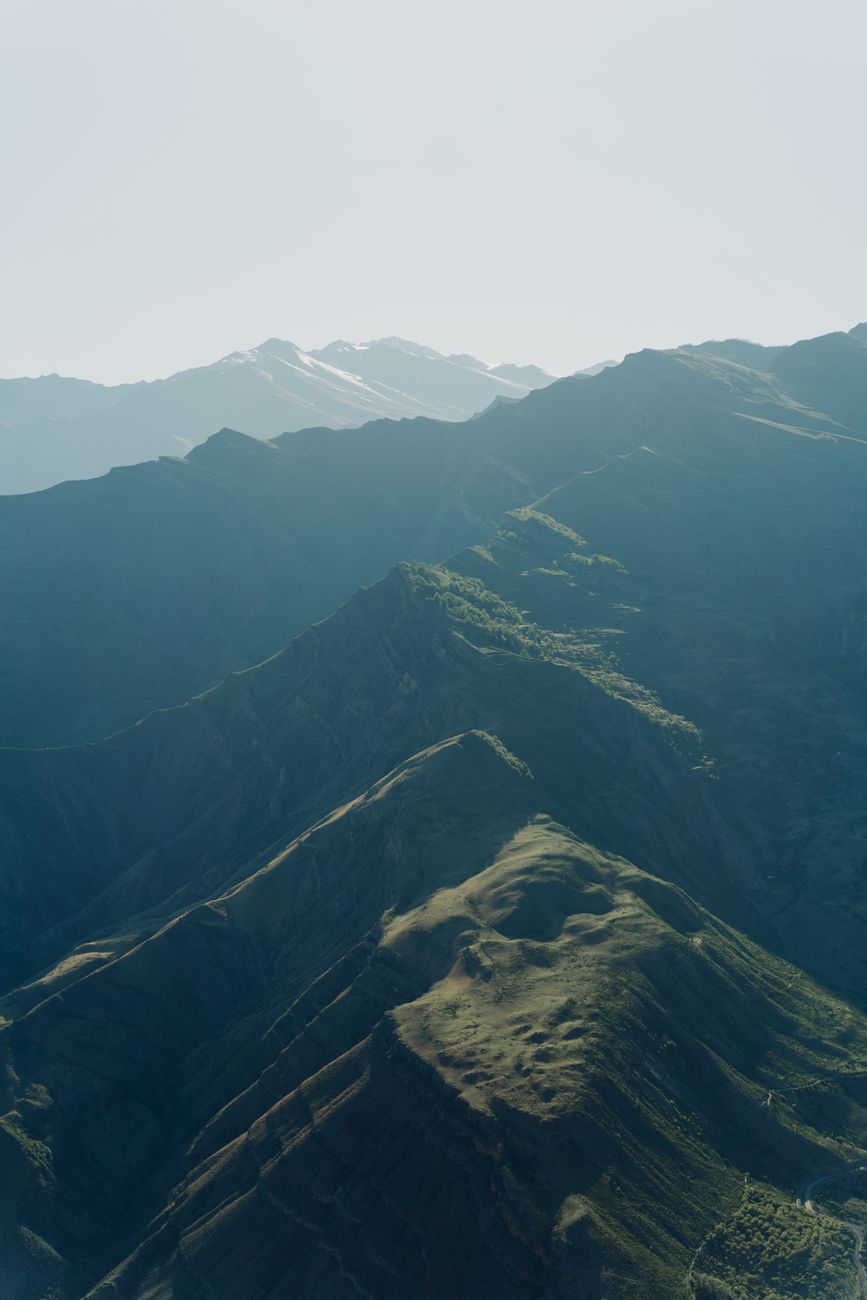Aerial shot capturing the lush, fog-covered mountain landscape · Hazorchashma — Fann Mountains, Tajikistan, Uzbekistan