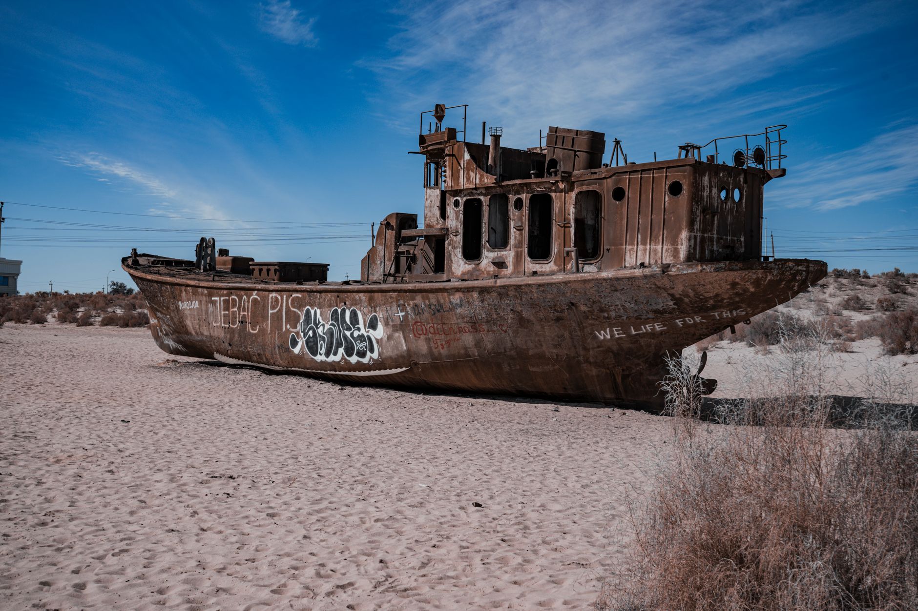A rusted ship stranded in the desert of the dried Aral Sea, Uzbekistan, symbolizing ecological disaster · Muynak & the Aral Sea, Uzbekistan