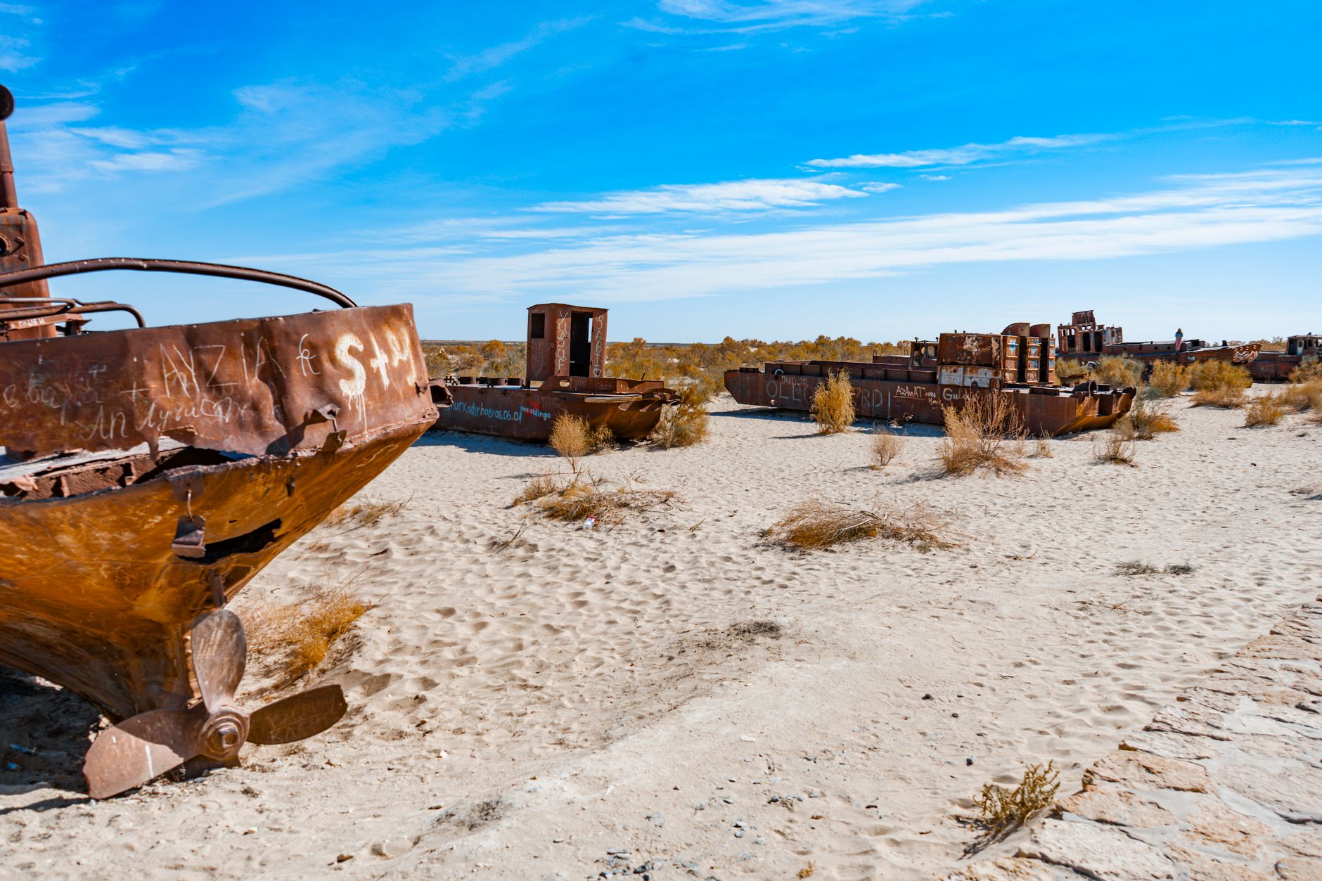 Abandoned rusty ships stranded on the dry Aral Sea bed in Uzbekistan, showcasing desertification · Muynak & the Aral Sea, Uzbekistan