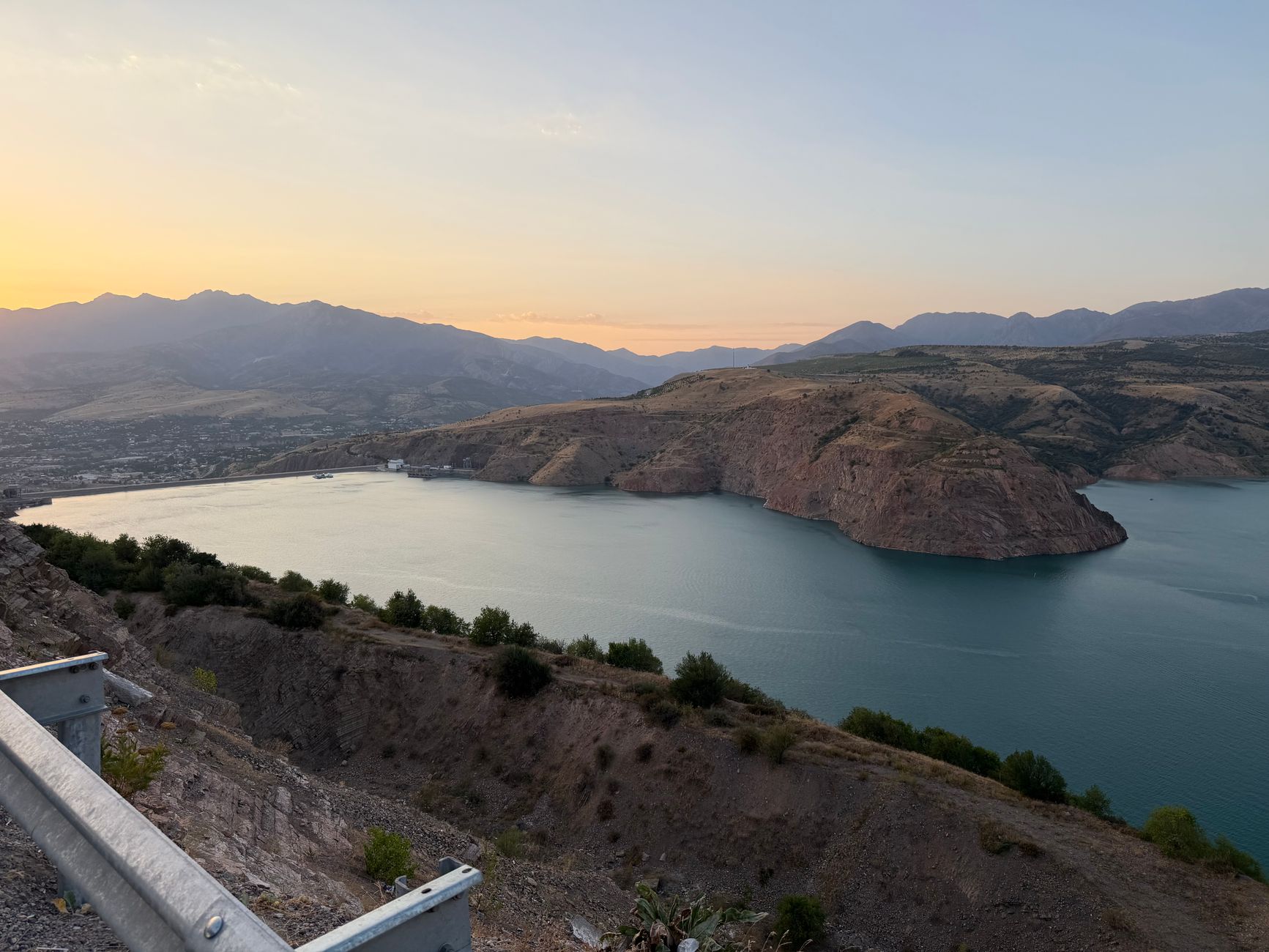 Scenic landscape of Charvak Reservoir with mountains and sunset, captured from a high vantage point · Nurata & Aydarkul, Uzbekistan