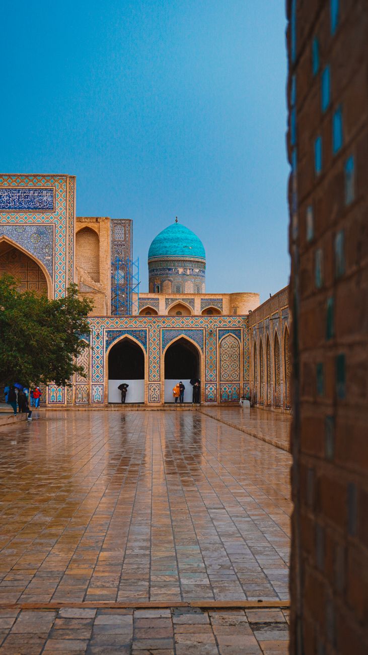 Stunning architecture of a historic madrasa in Bukhara, Uzbekistan, showcasing vibrant blue tiles